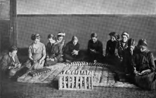 Children in a country school scoring corn. Everywhere the
country is responding to the call of Progress, and these members of a
new generation are striving to reach the best.